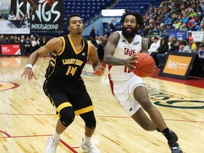JR Holder, right, of the Sudbury Five, drives to the basket against Mareik Isom, of the London Lightning, during basketball action at the Sudbury Community Arena in Sudbury, Ont. on Monday December 30, 2019.