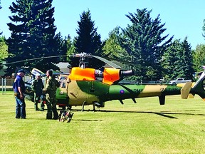 Bomber Command Museum of Canada director Karl Kjarsgaard, left, greets the flight crew of the Gazelle helicopter that landed in the ballpark adjacent to the museum Sept. 10.