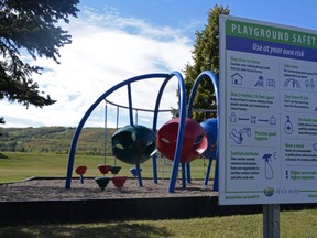 A sign gives safety tips on how to prevent the spread of COVID-19 for a playground at Riverfront Park in Peace River, Alta. on Saturday, Sept. 12, 2020.