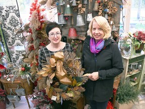Melodee Delrue, owner of Syd Kemsley Florist, left, and Marianne Johnstone from IODE Captain Garnet Brackin hold up a wreath inside Delrue's Chatham store Oct. 30, 2019. The 2020 edition of the event has been cancelled. (Tom Morrison/Postmedia)