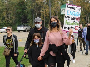 Protestors with the People Vs. Predators group marched in Spruce Grove on Saturday.