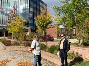 Shane Moyer speaks to Ron Melnyk, the city's bylaw officer Tuesday afternoon. Moyer who has been sleeping outside since last week says he will pack up the tents however he will be back tomorrow to continue to raise awareness about the city's homelessness population and the need for more shelters and supports.