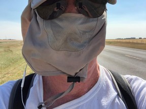 Gary Mason wears adequate sun protection as he and Tracey Paluck journey 33-km in 33 degree weather through the M.D. of Pincher Creek in August.
