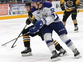 Jack Hanley, left, of the Hamilton Bulldogs, and Blake Murray, of the Sudbury Wolves, battle for position during OHL action at the Sudbury Community Arena in Sudbury, Ont. on Friday December 15, 2017.