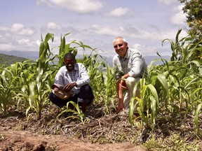 Malawian farmer Danny Gwira is showing his farm plot to Henry Reinders (r9ght), of Meaford, Ont., right, who traveled to Malawi on a Foodgrains Bank learning tour to see how members, donors and supporters are making a difference overseas in 2018. Handout/Postmedia Network