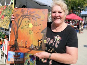 Sherrie Piens of MP Designs at Work shows one of her paintings at the second annual Art in the Park Chatham at Downtown Chatham Centre in Chatham on Sept. 26. Mark Malone/Postmedia Network