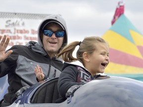 Mike Chalcraft, left, and daughter Peyton ride one of the midway attractions at the Brigden Fair in 2019. The pandemic has put a chill on fall fairs this year, including Brigden's, which attracted over 55,000 visitors last Thanksgiving weekend. File photo/Postmedia Network