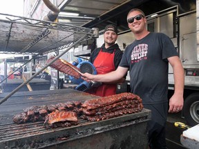Will Haase, right, owner of Silver Bullet Bar-B-Q, and Daniel Bureau work the grill Sunday at the Tillsonburg 'Takeout' Ribfest. (Chris Abbott/Norfolk Tillsonburg News)