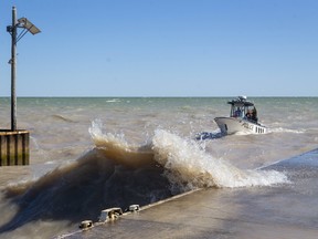 An OPP search and recovery boat returns to Port Glasgow harbour during rough conditions on Lake Erie on Sept. 20 after searching for missing sailor Reginald Fisher. Mike Hensen/Postmedia Network