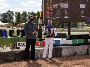 Hanover Raceway Assistant to the GM Tony Elliott presents Doug McNair with his Top Dash Winning and Top Percentage Driver awards.