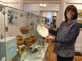 Peg Kivi, a member of the gift shop committee at the Lawrence House Centre for the Arts in Sarnia, holds one of the items available for sale. The gift shop is reopening Friday after temporarily closing at the beginning of the pandemic in March.
