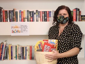 Tiffany Niece, owner of Sloths and Molasses in downtown Simcoe, is running a food drive for the month of October. People are able to bring in a non-perishable item and in turn, can pick a used book to take home. (ASHLEY TAYLOR)