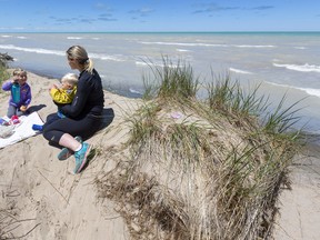 Alan Pullman and Becki Dries and their children, Everlea and Kellan, enjoy a secluded picnic lunch above the beach at Pinery Provincial Park on May 31. Pinery and other provincial parks enjoyed a seven per cent increase in visits this past summer, thought mostly due to the COVID-19 pandemic. Mike Hensen/Postmedia Network