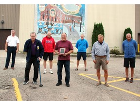 Past and present members of teams coached by Roy Dagenais recently gathered to present him with a plaque to commemorate his 26 years as a coach in the Pembroke Sportsmens Hockey League. On hand for the presentation outside the Pembroke Memorial Centre (from left) were Daniel Levasseur, Graham Matthieu, league president Jerry Johnston, Dagenais, Joel Levasseur, Ed Cotnam and Denis Levasseur.