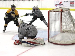 NOJHL file photo

Caleb Wood, then of the Soo Eagles (left), shovels a backhander into the Espanola Express goal in NOJHL action