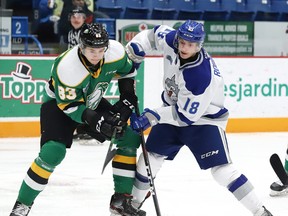 Owen Robinson, right, of the Sudbury Wolves, and Hunter Skinner, of the London Knights, battle for the puck during OHL action at the Sudbury Community Arena in Sudbury, Ont. on Friday December 20, 2019.
