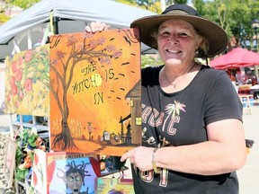 Sherrie Piens of MP Designs at Work shows one of her paintings at the second annual Art in the Park Chatham at Downtown Chatham Centre in Chatham, Ont., on Saturday, Sept. 26, 2020. Mark Malone/Chatham Daily News/Postmedia Network