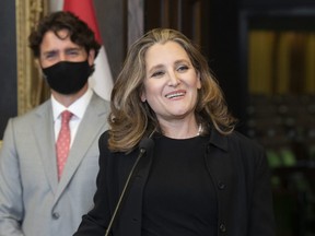 Prime Minister Justin Trudeau looks on as Finance Minister Chrystia Freeland smiles as she responds to a question during a news conference on parliament hill in Ottawa on August 18, 2020. (THE CANADIAN PRESS/Adrian Wyld)