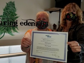 Capturing Eden, a recreational marijuana retail shop, is set to open in Owen Sound Saturday. Shop manager, Angela Messerschmidt, left, and Wanita Johnstone, a shop owner, hold up their city business licence certificate Tuesday, Sept. 1, 2020. (Scott Dunn/The Sun Times/Postmedia Network)