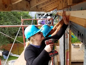 Pauline Emmerson attatches strapping with screws and a drill with the help of Penelope Trudgeon Saturday, Sept. 12, 2020 at this Habitat for Humanity build in Owen Sound, Ont. (Scott Dunn/The Sun Times/Postmedia Network)