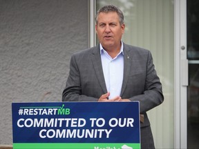 Justice Minister Cliff Cullen addresses the media outside the offices of the Association of Manitoba Municipalities in Portage la Prairie on Monday. The Manitoba government is seeking feedback from the public on proposed measures to combat rural crime and metal theft through a new online questionnaire. (Aaron Wilgosh/Postmedia)