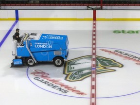 Eric Turrell, a facility operator at Budweiser Gardens lays down another millimetre of ice as they build it up to the required 3.2 cm thickness for the season in London, Ont. (Mike Hensen/The London Free Press)