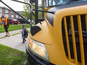 A returning pupil steps off the school bus at Lord Nelson elementary school in east London. Photograph taken on Monday September 14, 2020. Mike Hensen/The London Free Press/Postmedia Network