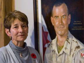Carolyn Wilson lost her son, Trooper Mark Wilson, in Afghanistan in 2006. She's pictured here next to his portrait, in 2010. (Mike Hensen/The London Free Press)