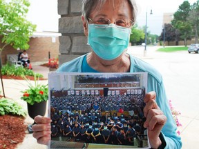 Owen Sound resident Louise Gamble holds up a photograph of students at TamKang private school in Taiwan who collected and donated masks for distribution to long-term care homes, daycare centres and other organizations in Grey County. DENIS LANGLOIS