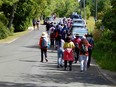 People on their way to Lion's Head lookout fill Moore Street in this photo taken last year. Northern Bruce Peninsula counci banned parking there in July and has endorsed looking at paid parking as a solution in high-traffic areas of the municipality. (David Rodgers photo)