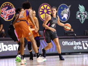 Bridget Carleton, right, of the Minnesota Lynx handles the ball against the Phoenix Mercury on Aug. 30, 2020, at Feld Entertainment Center in Palmetto, Florida. Copyright 2020 NBAE (Photo by Ned Dishman/NBAE via Getty Images)
