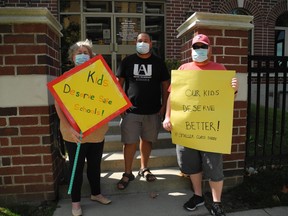 Karen McNeill, left, Dennis Jackson and James Messecar were the only ones to show up for a protest at MPP Will Bouma's office on Sunday, demanding that the province cut class sizes to protect children from COVID-19.