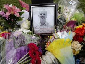 An impromptu memorial for Dr. Walter Reynolds is shown in Red Deer, Alta., Tuesday, Aug. 11, 2020. Reynolds, a 45-year-old father of two young girls, died in hospital after he was attacked Monday morning at the Village Mall Clinic in Red Deer, Alta. THE CANADIAN PRESS/Jeff McIntosh