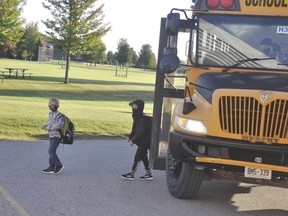 Students depart the bus on the first full-day of school at Upper Thames elementary Sept. 17, wearing masks of course. ANDY BADER/MITCHELL ADVOCATE