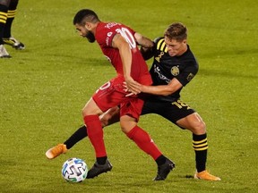 Toronto FC midfielder Alejandro Pozuelo works the ball against Columbus Crew midfielder Sebastian Berhalter last night. USA TODAY