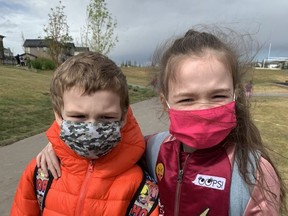 Siblings Ben, age 6, and Eva Button, 8, mask up for their first day back at St. Veronica School. Submitted