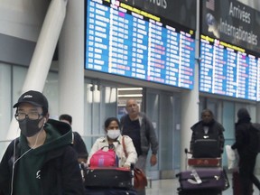 Passengers arrive at Pearson International Airport on Wednesday, March 4, 2020.