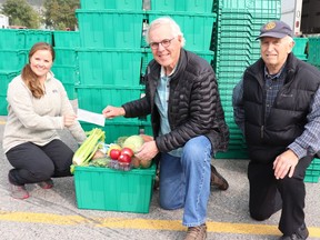 Randi Rinaldi (left) of the Good Food Box accepts a $10,000 cheque from Bob Ellard (centre) and Doug Jones (right) of Canmore Rotary. Photo submitted.