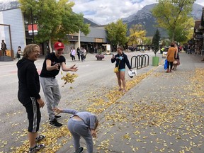 Children play in the autumn leaves on Sept. 20 on Main Street Canmore before it re-opens to vehicular traffic Sept. 24. Many of the traffic pattern changes made over the summer will remain in place, including a speed limit of 30 km/h in the Town Centre and a right turn only exiting 8 (Main) Street. Photo Marie Conboy/ Postmedia.