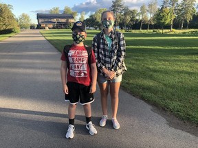 Nathan and Lauren Ferriss wait outside their Ameliasburgh home for the bus to take them to their first day of school at Harry J. Clarke Public School on Friday morning. The brother and sister were excited to return to school for the first time since March. BRUCE BELL
