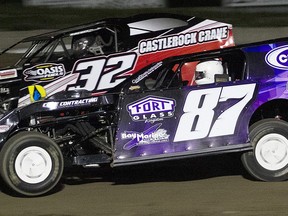 Picton's Andrew Hennessy (No. 87) took the lead from Napanee's Doug O'Blenis (No. 32) with two laps remainng to win the Bainer's OilGARD 25 Lap Canadian Modified event Saturday at Brighton Speedway. ROD HENDERSON PHOTO