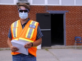 Quinte Health Care screener Damian Empey stands outside the COVID-19 assessment centre in the former Quinte Secondary School June 11 in Belleville. Authorities expected the centre's 10,000th sample to be collected Sept. 16 as school reopenings drive a dramatic spike in the demand for testing.