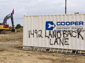 Four people were charged Thursday with violating a court order in relation to a housing development in Caledonia.