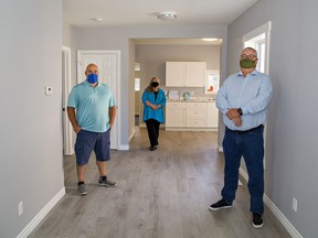 Habitat for Humanity Brant-Norfolk build service director Joe Scrocco (left), director of fund development and communications Lynda Henriksen, and CEO Dan Brooks stand inside a Brantford geared-to-income home the organization renovated for Brantford Native Housing.