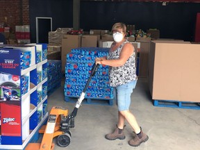 Tammy Dunham, a volunteer at Brant United Way, organizes donations in preparation for this year's Giant Warehouse Sale, which had been postponed due to the COVID-19 pandemic. United Way officials say they have come up with way to hold the sale safely.