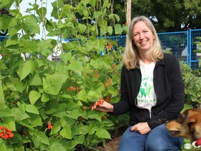 City Coun. Cheryl Antoski, with her dog Copper at the Lynden Hills community garden, is chair of the Equal Ground Community Gardens initiative, which has so far this year produced more than 3,500 pounds of produce for the food banks in Brantford and Paris.