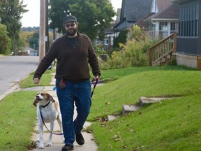 Scott Empringham recently moved to Simcoe from Toronto and has opened his dog-walking business, Underdogs. Pictured with him is Winston.