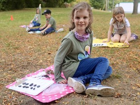 Abigail Sonnenberg, a student in the Grade 1 and 2 split French immersion class at Walsh Public School, participates in an outdoor math lesson on Tuesday afternoon. ASHLEY TAYLOR