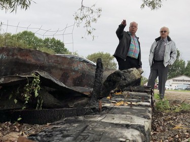 Elizabethtown-Kitley Coun. Rob Smith, left, speaks to United Counties Warden Pat Sayeau near some of the charred remains of the original Five Mile Light at G.C. Hudson Supply on Tuesday afternoon. (RONALD ZAJAC/The Recorder and Times)