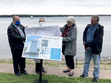 Elizabethtown-Kitley Coun. Rob Smith, left, a member of the Five Mile Light rebuild committee, unveils a plaque with township heritage committee members Mary-Anne Gibson, Tracy Gayda and Jim McMullen. (RONALD ZAJAC/The Recorder and Times)